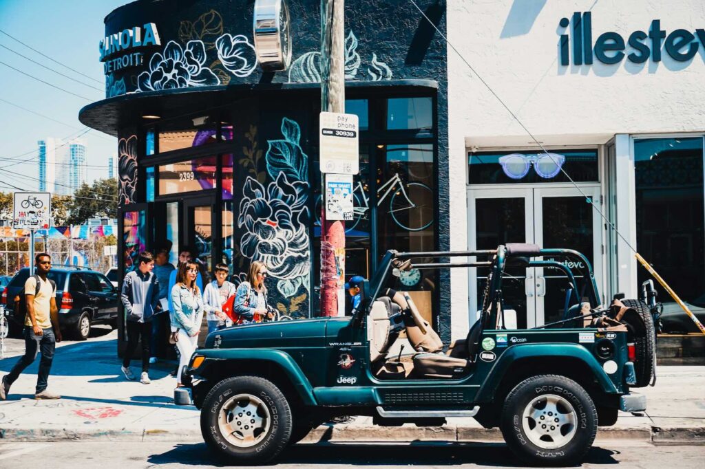 Jeep parked in front of colorful boutique shops in Miami Beach, Florida