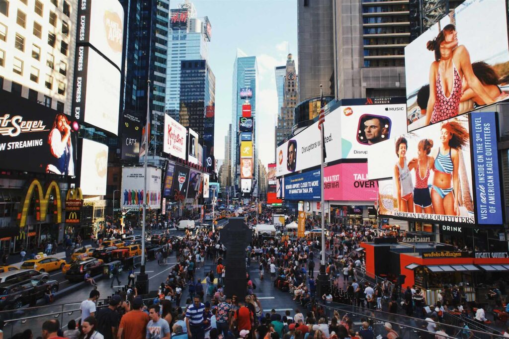 Street view of Times Square New York with neon signs and busy city life during New York City break