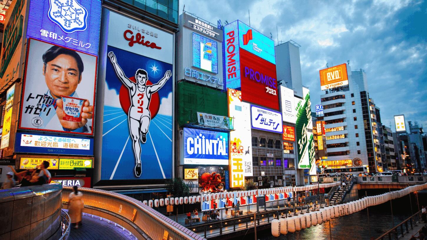 Osaka Dotonbori street with LED buildings, stores and water during vacation Japan