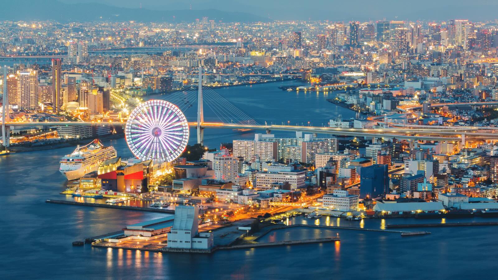View of Osaka Ferris wheel and river bridge during vacation Japan