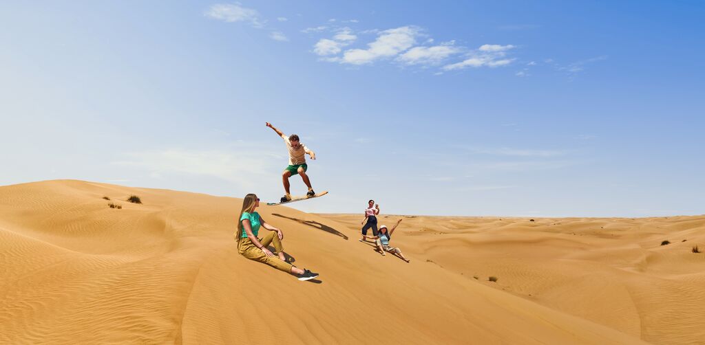 Sandboarding in the desert near Dubai, United Arab Emirates