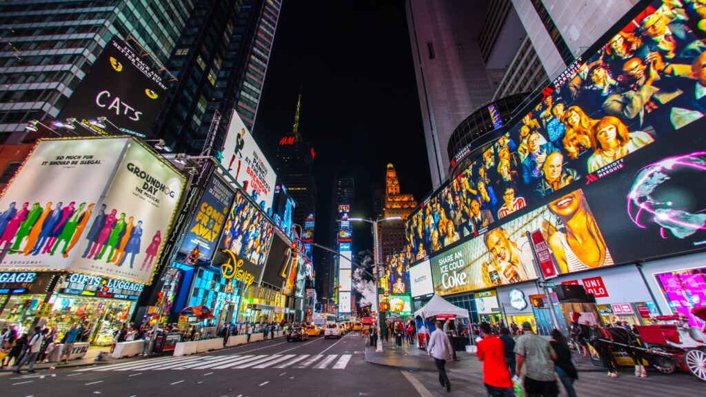 Times Square New York with neon signs and busy city life during New York City break