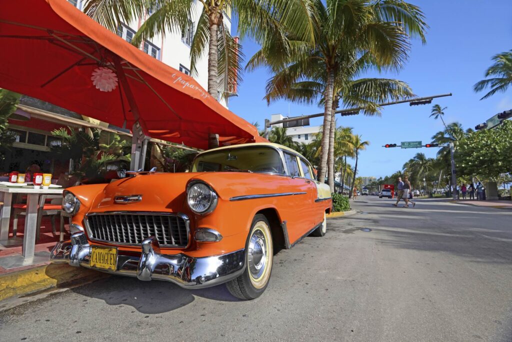 Classic car in front of art deco hotel in Miami Beach, Florida during vacation
