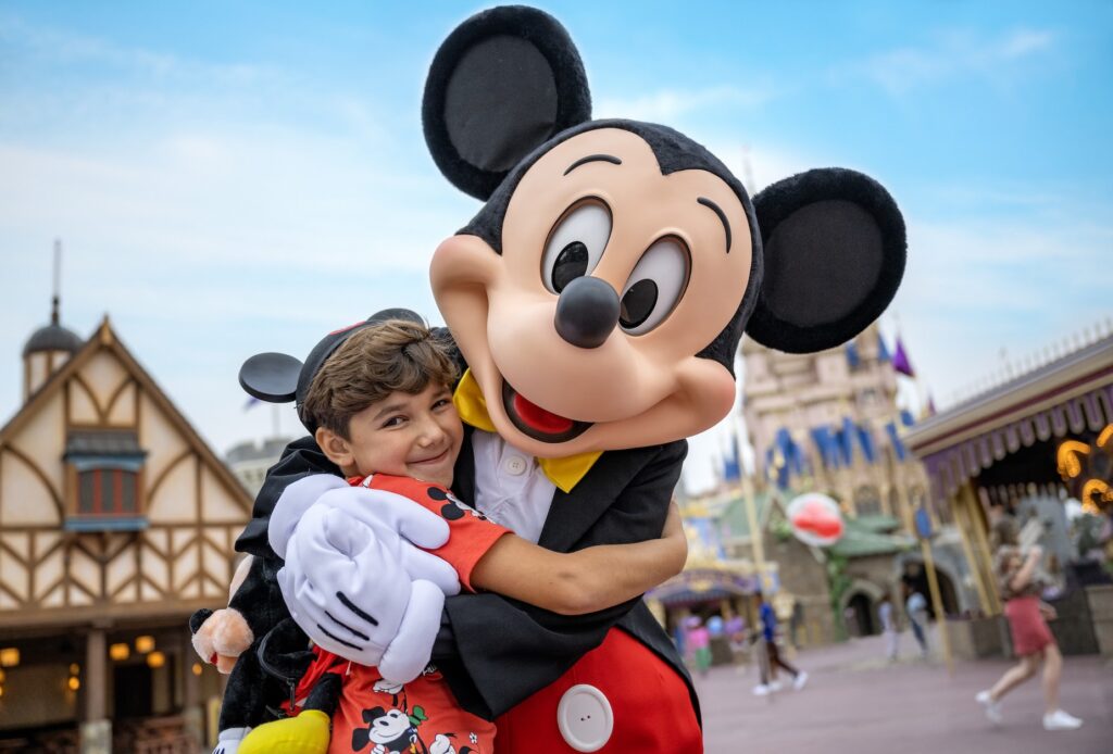 Disney Dining Plan Magical moment: child hugs Mickey Mouse in Fantasyland during Walt Disney World vacation